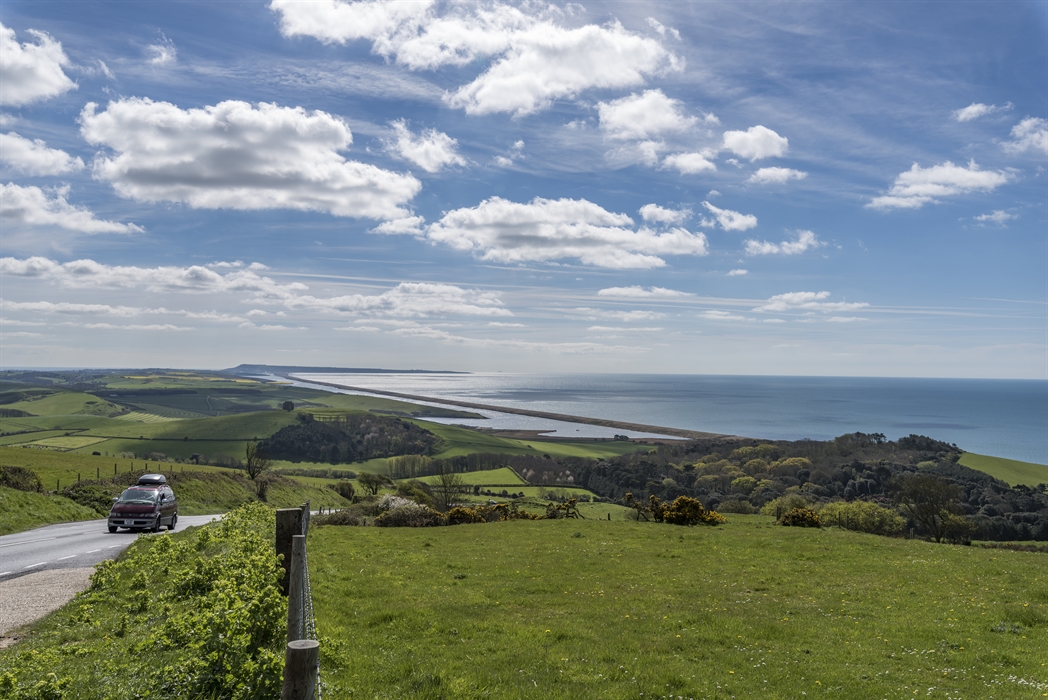 Chesil Beach. 21st August 2018. Two males enjoy swimming off Chesil Beach,  Portland, in Dorset, the